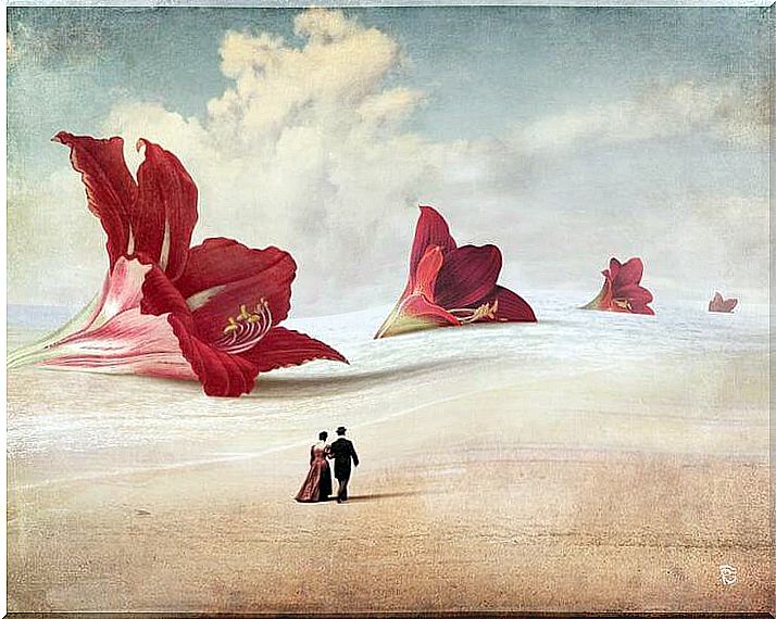 couple walking in front of giant flowers