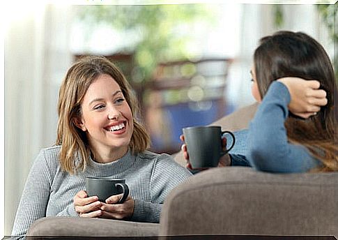 Girlfriends talking while drinking coffee