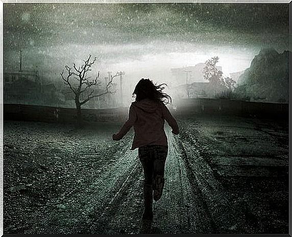 girl running down dark road