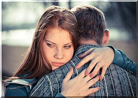 Girl with passive aggressive disorder hugging her partner