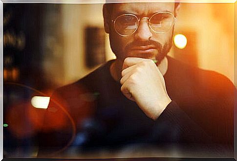 Man with glasses thinking about negotiating