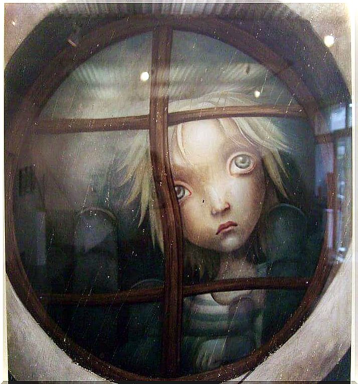 Sad child behind the window