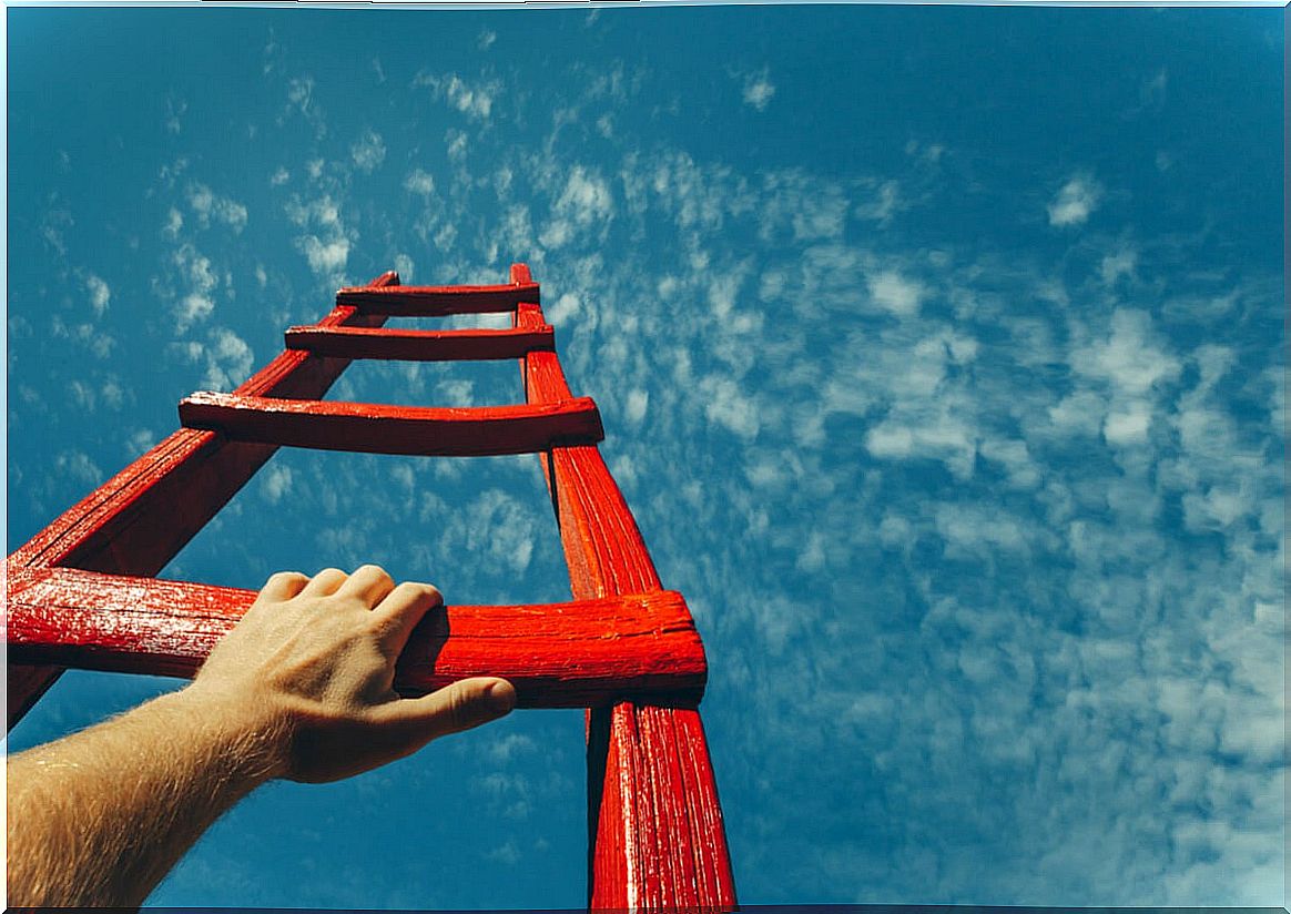 Man climbing a red ladder