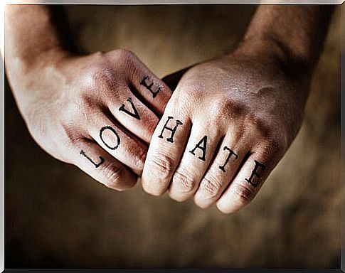 Hands with words love and hate tattooed