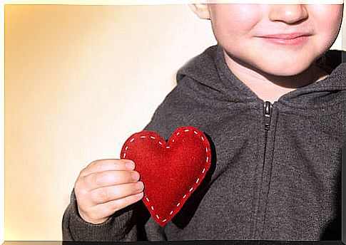 Child with a heart to represent unconditional love for our children
